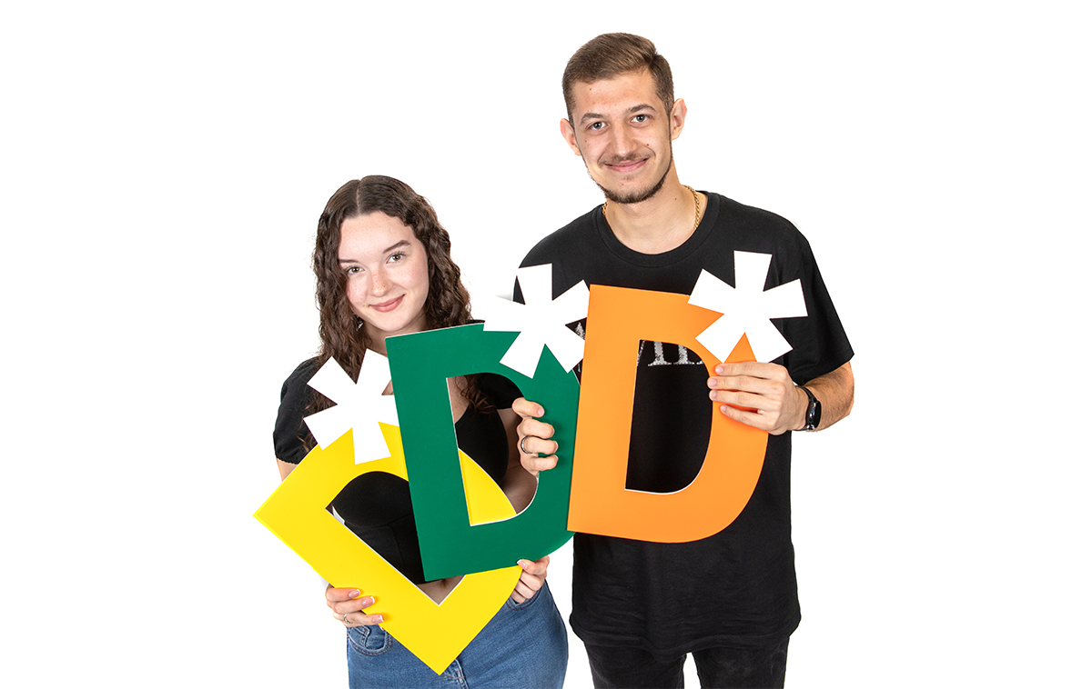 Students holding Distinction grade props