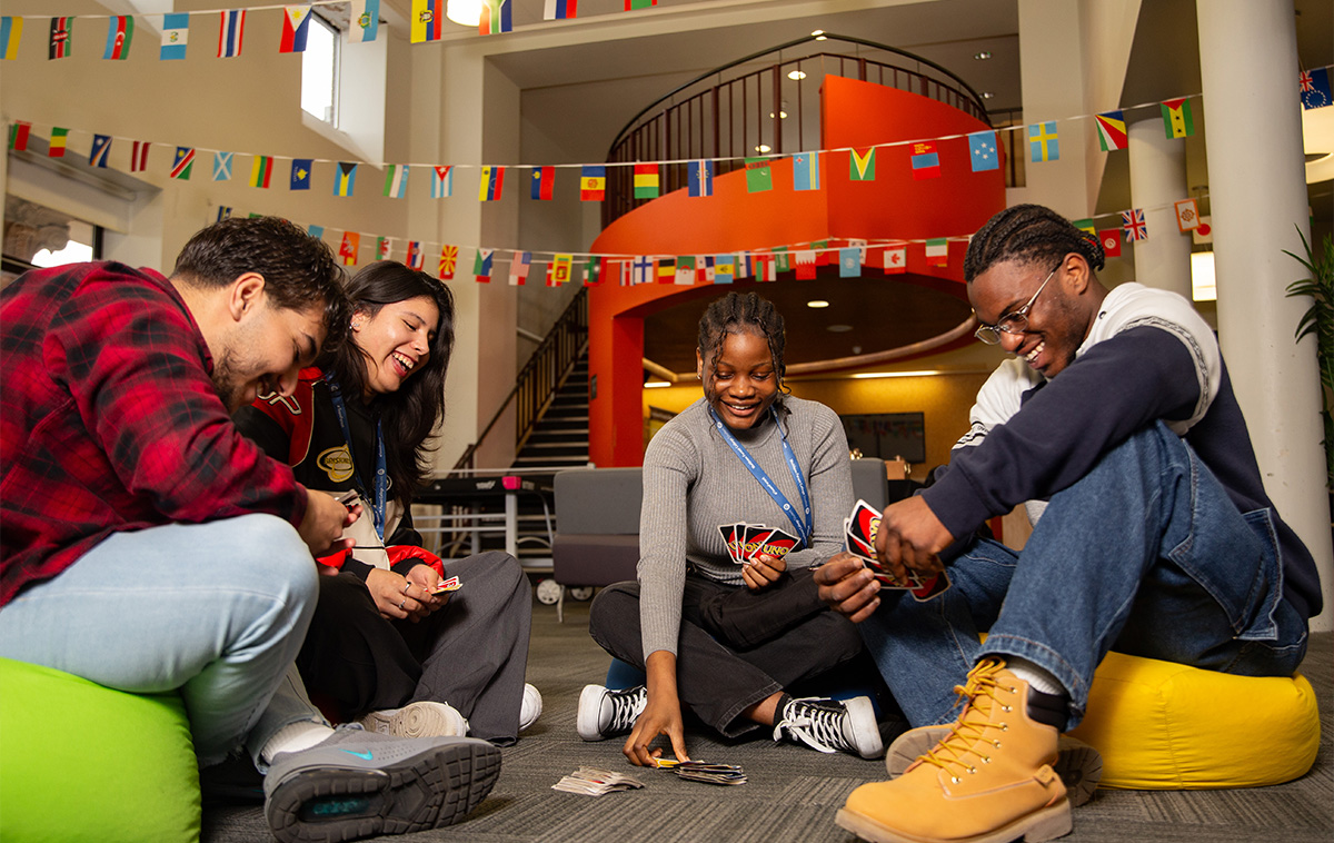 Students playing card games in the common room